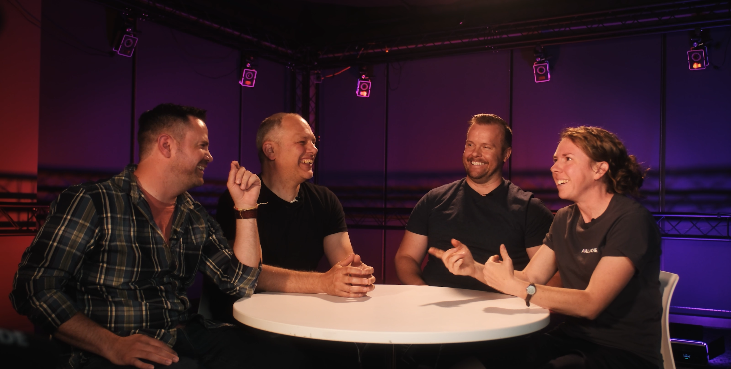 People seated around a table laughing